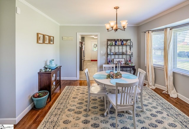 849 Harvey Rd, Greer, SC 29651 - dining area with crown molding, a chandelier, and wood finished floors