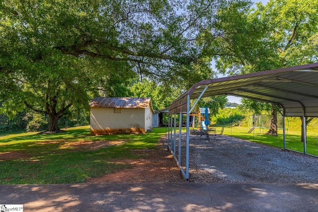 849 Harvey Rd, Greer, SC 29651 - view of green lawn featuring a detached carport, driveway, and an outbuilding