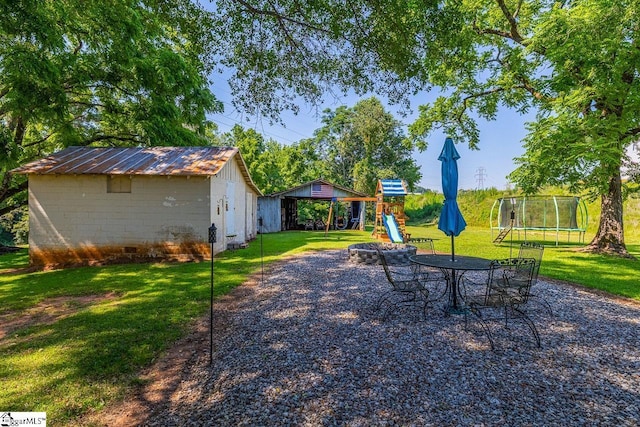 849 Harvey Rd, Greer, SC 29651 - view of green lawn with a trampoline, a playground, and a storage shed