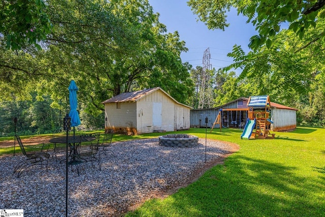 849 Harvey Rd, Greer, SC 29651 - view of yard with an outdoor fire pit, a playground, and a storage shed