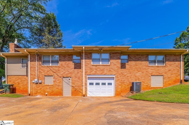 849 Harvey Rd, Greer, SC 29651 - rear view of house with an attached garage, concrete driveway, a chimney, and brick siding