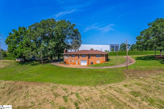 849 Harvey Rd, Greer, SC 29651 - back of property with a chimney, brick siding, a lawn, and a garage