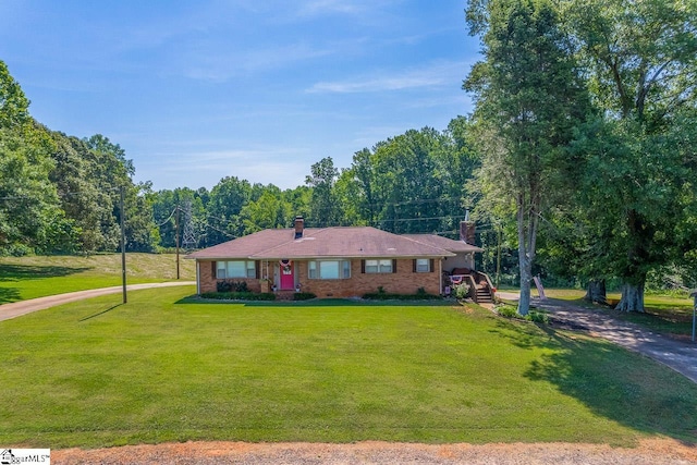 849 Harvey Rd, Greer, SC 29651 - ranch-style home with a chimney, a front yard, driveway, and brick siding