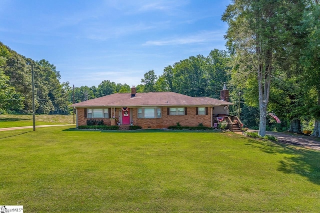 849 Harvey Rd, Greer, SC 29651 - ranch-style home featuring a chimney, a front yard, and brick siding