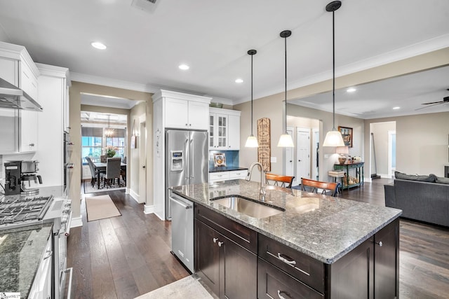 101 Mares Head Pl, Taylors, SC 29687 - kitchen with appliances with stainless steel finishes, ornamental molding, dark brown cabinets, white cabinetry, and open floor plan