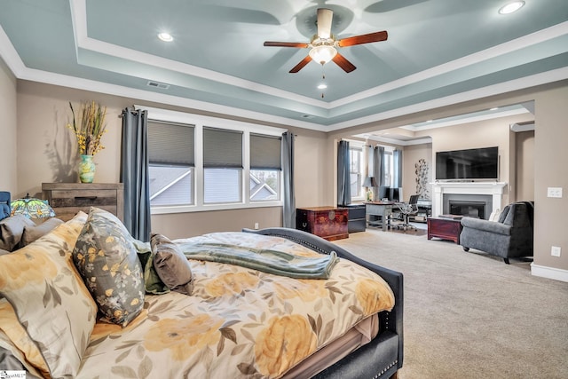 101 Mares Head Pl, Taylors, SC 29687 - bedroom featuring a tray ceiling, carpet, crown molding, a glass covered fireplace, and recessed lighting