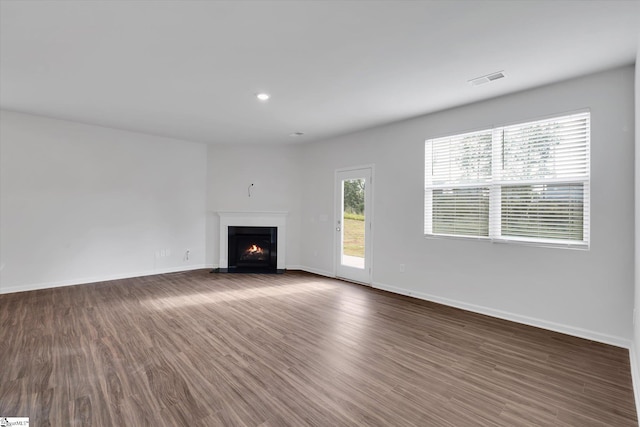 313 E Compass Way, Easley, SC 29640 - unfurnished living room with wood finished floors, a fireplace with flush hearth, and recessed lighting