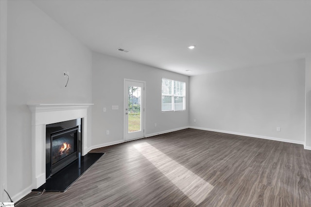 313 E Compass Way, Easley, SC 29640 - unfurnished living room featuring a glass covered fireplace, dark wood finished floors, and recessed lighting