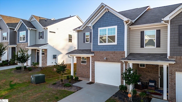 313 E Compass Way, Easley, SC 29640 - townhome / multi-family property featuring brick siding, an attached garage, and driveway