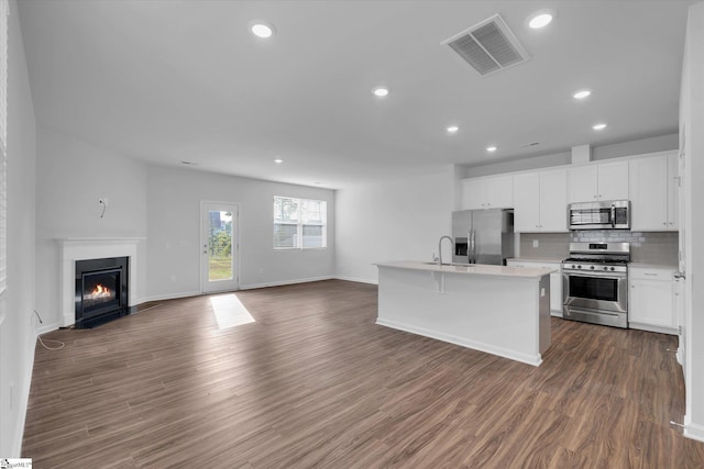 313 E Compass Way, Easley, SC 29640 - kitchen featuring appliances with stainless steel finishes, open floor plan, backsplash, recessed lighting, and white cabinetry