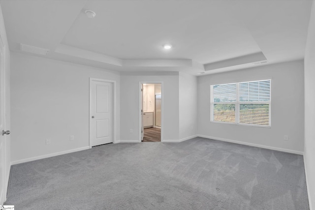 292 E Compass Way, Easley, SC 29640 - unfurnished bedroom featuring a raised ceiling, carpet, and ensuite bathroom