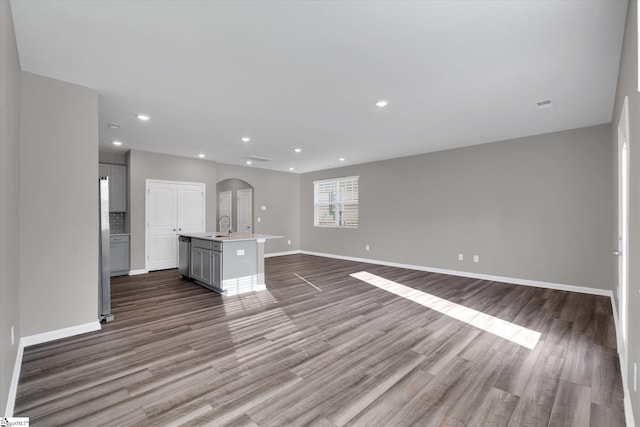 291 E Compass Way, Easley, SC 29640 - unfurnished living room featuring arched walkways, wood finished floors, and recessed lighting