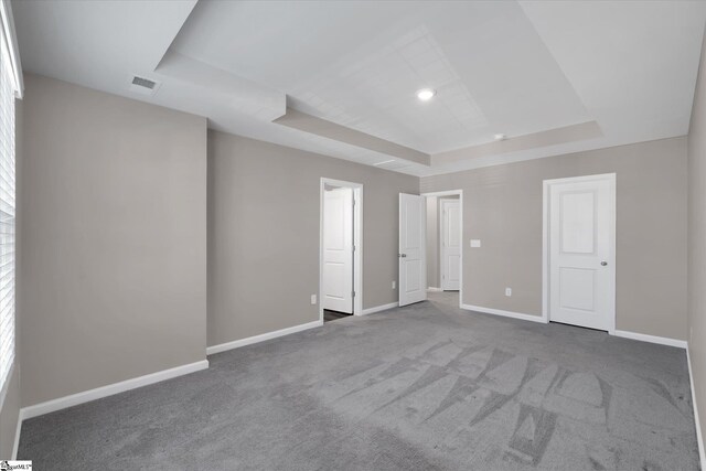 291 E Compass Way, Easley, SC 29640 - unfurnished bedroom with a tray ceiling and carpet