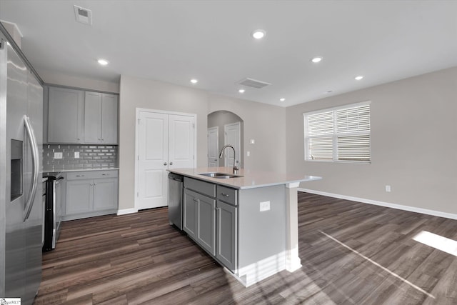 291 E Compass Way, Easley, SC 29640 - kitchen with gray cabinetry, arched walkways, dark wood-type flooring, appliances with stainless steel finishes, and recessed lighting