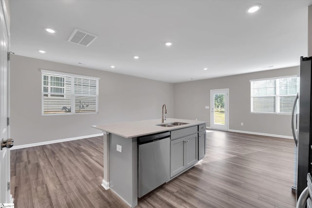 291 E Compass Way, Easley, SC 29640 - kitchen featuring appliances with stainless steel finishes, open floor plan, wood finished floors, light countertops, and a kitchen island with sink