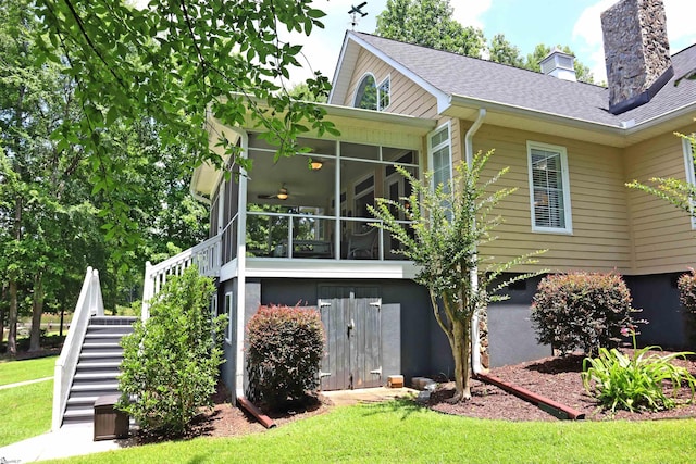 224 Seabright Cir, Cross Hill, SC 29332 - back of house with stairway, a sunroom, a chimney, a lawn, and roof with shingles