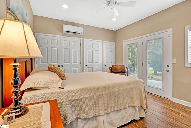 224 Seabright Cir, Cross Hill, SC 29332 - bedroom featuring a wall mounted air conditioner, access to outside, wood finished floors, two closets, and recessed lighting