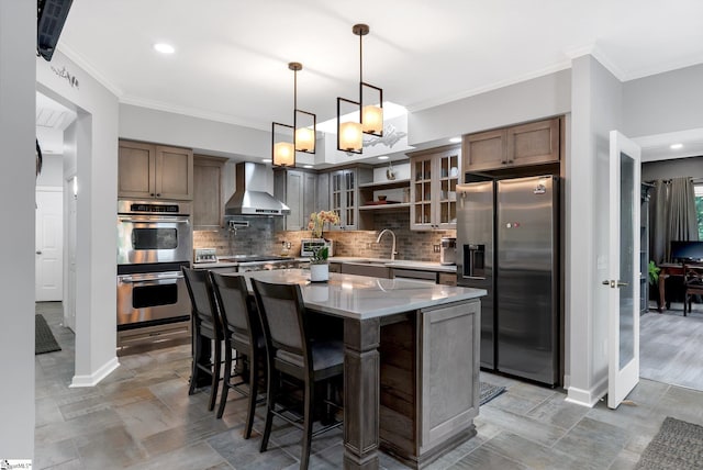 24 Lighthouse Way Dr, Salem, SC 29676 - kitchen featuring appliances with stainless steel finishes, wall chimney exhaust hood, tasteful backsplash, a kitchen island, and a breakfast bar area