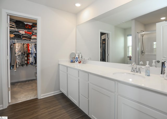 228 Anna Gray Cir, Easley, SC 29640 - bathroom with a walk in closet, a shower stall, double vanity, wood finished floors, and recessed lighting