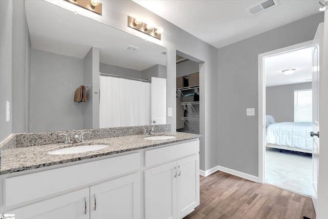 209 Long Grove Ln, Greer, SC 29650 - ensuite bathroom with wood finished floors, double vanity, and a shower with shower curtain