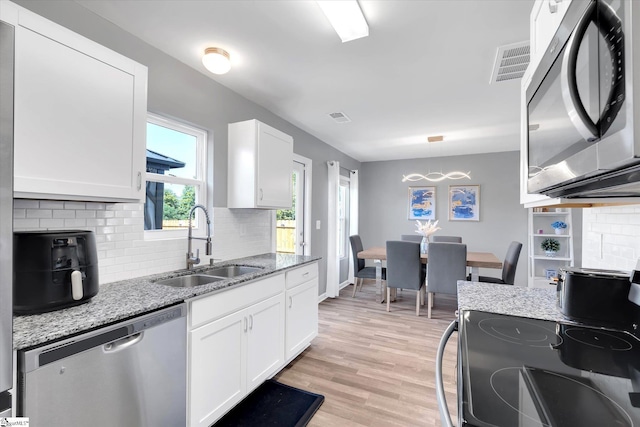 209 Long Grove Ln, Greer, SC 29650 - kitchen with dishwasher, decorative backsplash, white cabinetry, and light wood-style floors