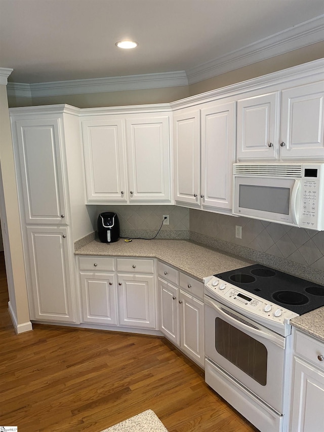 523 Meadowsweet Ln, Greenville, SC 29615 - kitchen featuring white appliances, light wood finished floors, white cabinetry, crown molding, and light countertops