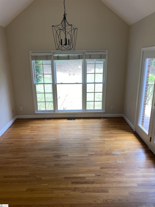 523 Meadowsweet Ln, Greenville, SC 29615 - unfurnished dining area with vaulted ceiling, a chandelier, and wood finished floors