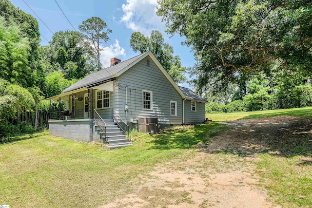 24 Burts St, Pelzer, SC 29669 - view of side of property with a porch, a chimney, a yard, crawl space, and a shingled roof