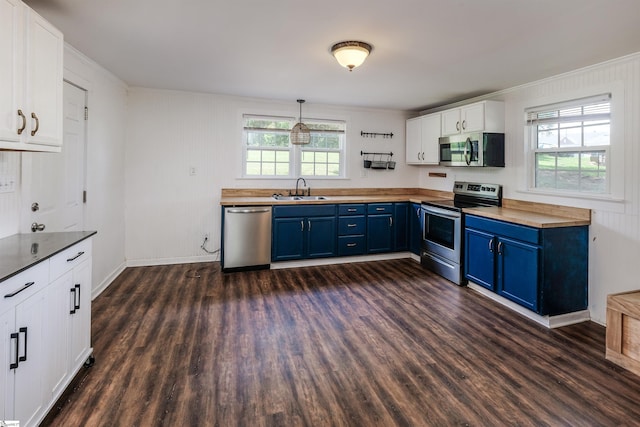 24 Burts St, Pelzer, SC 29669 - kitchen with appliances with stainless steel finishes, blue cabinetry, butcher block countertops, dark wood-type flooring, and white cabinets