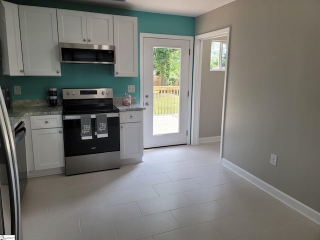 109 Mountain View Ave, Greer, SC 29650 - kitchen with appliances with stainless steel finishes, white cabinetry, light stone countertops, and light tile patterned flooring