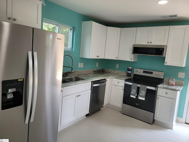 109 Mountain View Ave, Greer, SC 29650 - kitchen with stainless steel appliances, white cabinets, light stone countertops, recessed lighting, and light tile patterned floors
