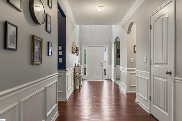 505 Jones Peak Dr, Simpsonville, SC 29681 - foyer with arched walkways, dark wood finished floors, wainscoting, a decorative wall, and crown molding