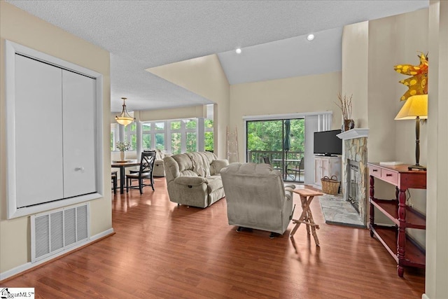 701 Loran Pointe Pointe, Seneca, SC 29672 - living area with healthy amount of natural light, wood finished floors, vaulted ceiling, recessed lighting, and a fireplace