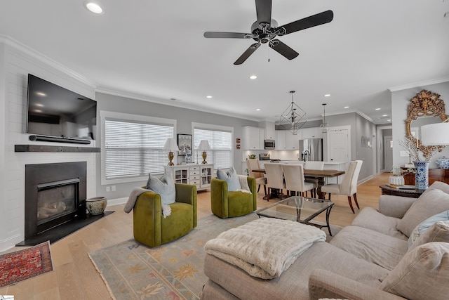 209 Pinckney St, Greenville, SC 29601 - living area featuring ceiling fan, recessed lighting, a large fireplace, light wood-type flooring, and crown molding