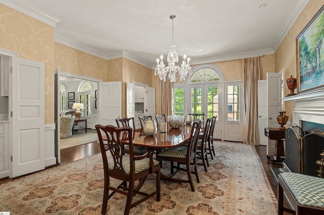 540 Crescent Ave, Greenville, SC 29601 - dining area featuring wallpapered walls, a chandelier, crown molding, wood finished floors, and a wainscoted wall