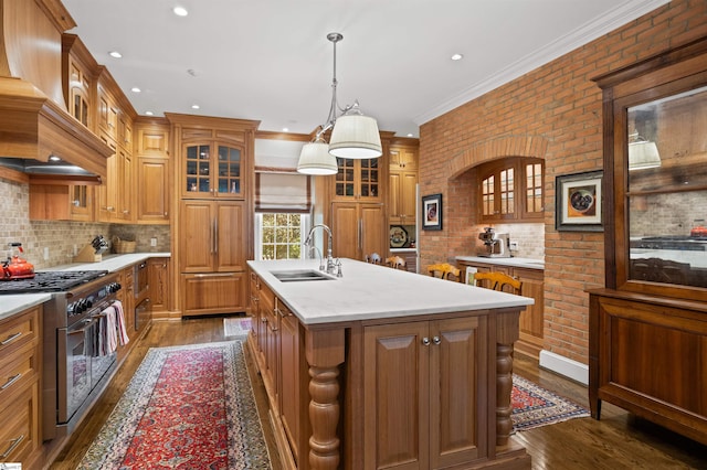540 Crescent Ave, Greenville, SC 29601 - kitchen featuring range with two ovens, dark wood-type flooring, brown cabinets, premium range hood, and crown molding