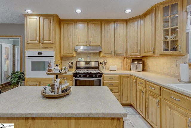 103 Birchwood St, Easley, SC 29642 - kitchen with white oven, stainless steel gas range, under cabinet range hood, light countertops, and recessed lighting