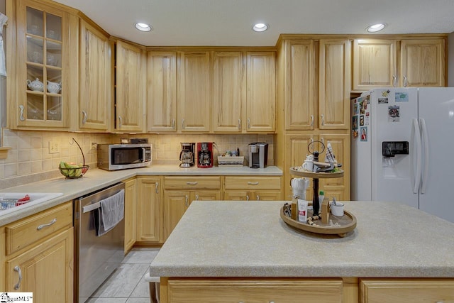 103 Birchwood St, Easley, SC 29642 - kitchen featuring stainless steel appliances, light brown cabinets, light countertops, glass insert cabinets, and recessed lighting