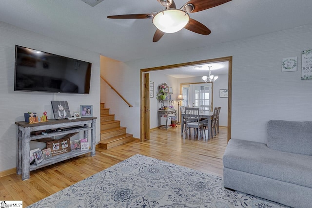 103 Birchwood St, Easley, SC 29642 - living area featuring stairway, light wood-type flooring, a chandelier, and a ceiling fan