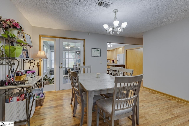 103 Birchwood St, Easley, SC 29642 - dining room featuring light wood finished floors, a textured ceiling, a chandelier, and french doors