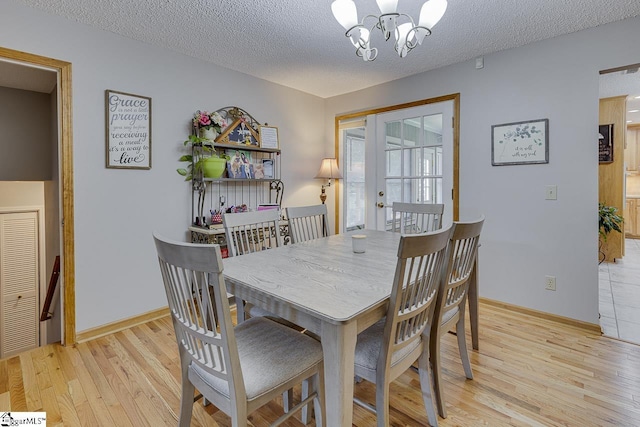 103 Birchwood St, Easley, SC 29642 - dining room featuring a chandelier, light wood-type flooring, and a textured ceiling
