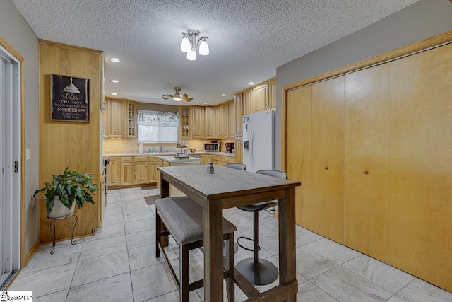 103 Birchwood St, Easley, SC 29642 - kitchen featuring white fridge with ice dispenser, light marble finish flooring, recessed lighting, light countertops, and ceiling fan