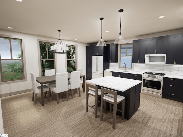 802 Anderson Rd Lot 16, Greenville, SC 29601 - kitchen featuring white appliances, dark cabinetry, healthy amount of natural light, tasteful backsplash, and recessed lighting