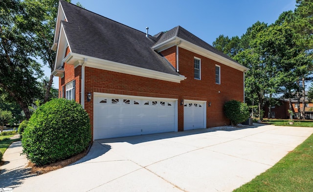 805 Carriage Hill Rd, Simpsonville, SC 29681 - view of side of property featuring brick siding, concrete driveway, roof with shingles, and a garage