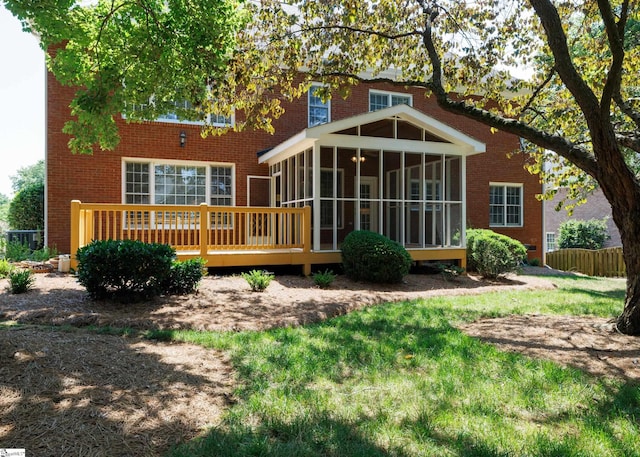 805 Carriage Hill Rd, Simpsonville, SC 29681 - rear view of house featuring a sunroom, brick siding, a wooden deck, and a lawn
