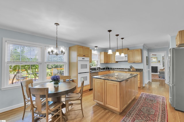 1 Redcliffe Rd, Greenville, SC 29615 - kitchen featuring appliances with stainless steel finishes, light brown cabinetry, a chandelier, a kitchen island, and crown molding