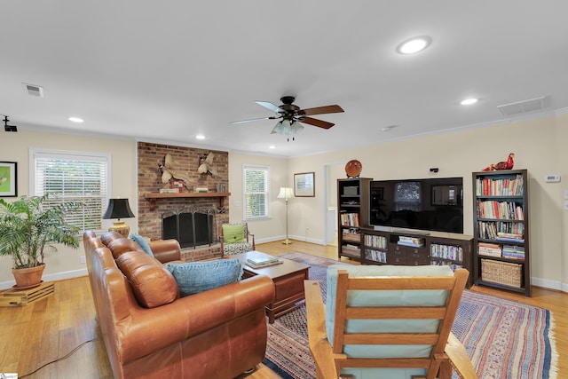 1 Redcliffe Rd, Greenville, SC 29615 - living area featuring light wood finished floors, a ceiling fan, crown molding, a brick fireplace, and recessed lighting