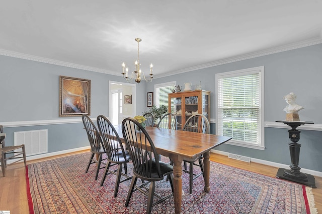 1 Redcliffe Rd, Greenville, SC 29615 - dining space with a chandelier, wood finished floors, and crown molding