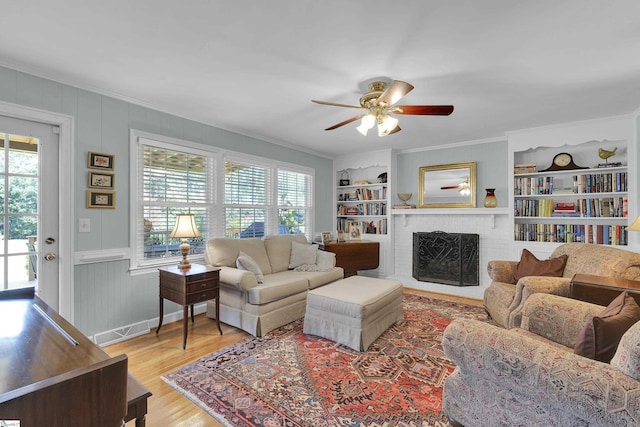 1 Redcliffe Rd, Greenville, SC 29615 - living area with crown molding, healthy amount of natural light, built in features, ceiling fan, and a brick fireplace