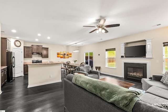 144 Caledonia Dr, Easley, SC 29642 - living room with ceiling fan, plenty of natural light, recessed lighting, dark wood-style floors, and a fireplace with flush hearth